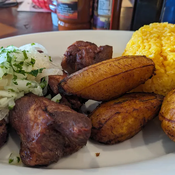 Pork, fried plantains, onions, rice.